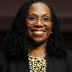 Justice Ketanji Brown Jackson at the Supreme Court steps, a portrait of judicial breakthrough and partnership.